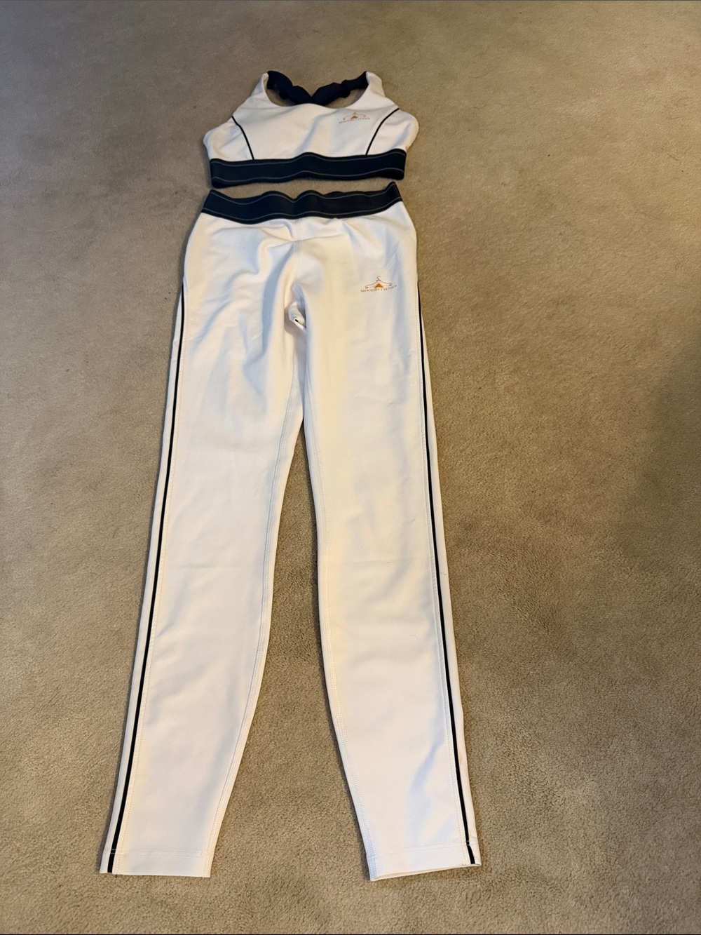 Mood by Tyessen White and Navy Two-Piece Athletic Set. Will turn heads